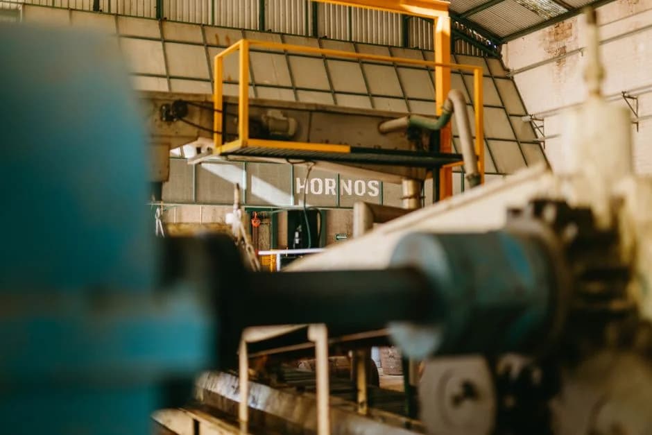 Close-up of steel conveyor systems and heavy industrial machinery inside a factory